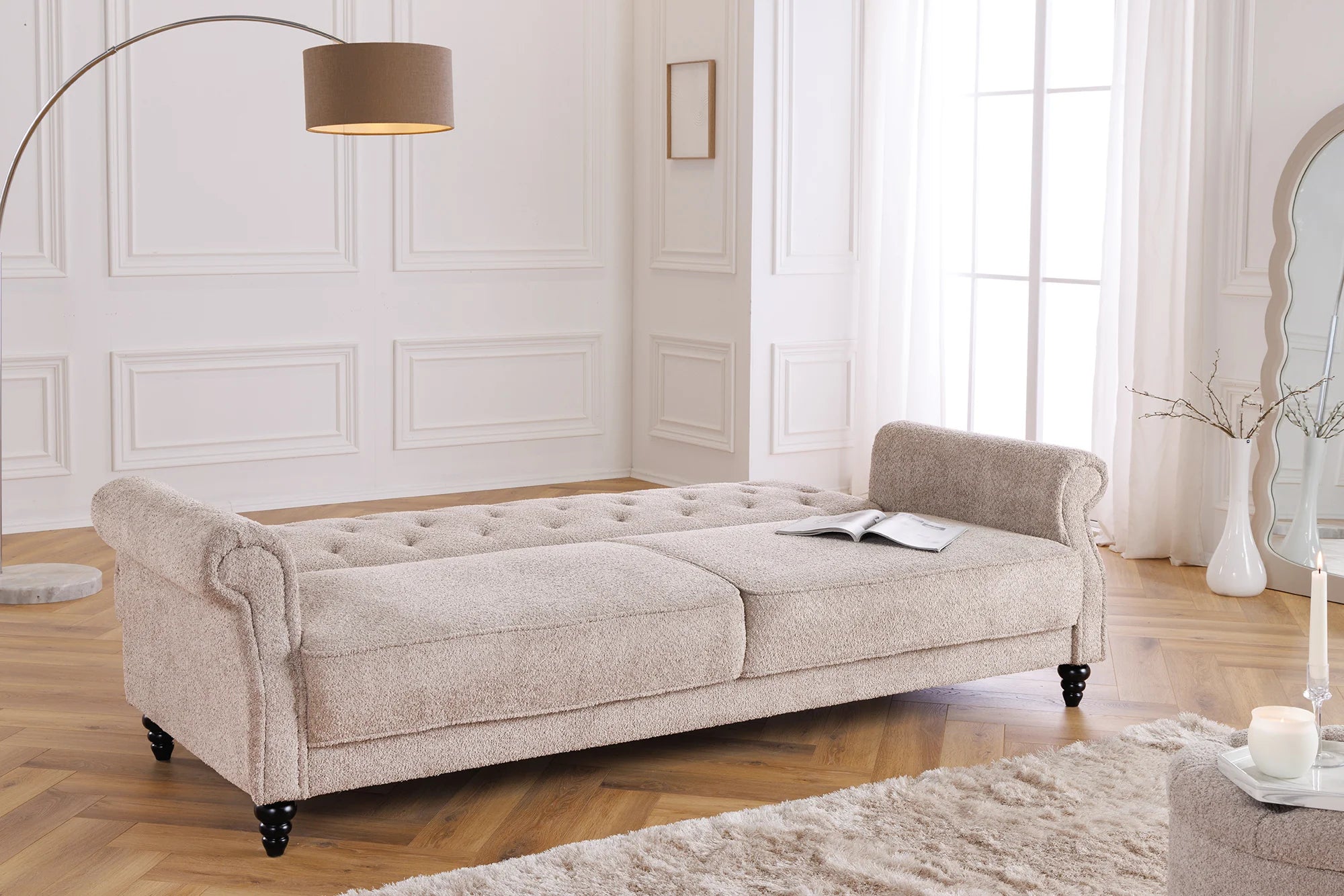 Trzyosobowa sofa w stylu klasycznym z tkaniny boucle, z pikowaniem, drewnianymi nogami i funkcją spania.