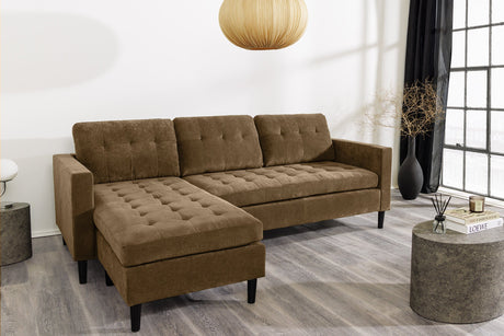 Nowoczesna sofa narożna w tkaninie cord, z otomaną lewą/prawą, tył tapicerowany, filcowe podkładki pod nogi