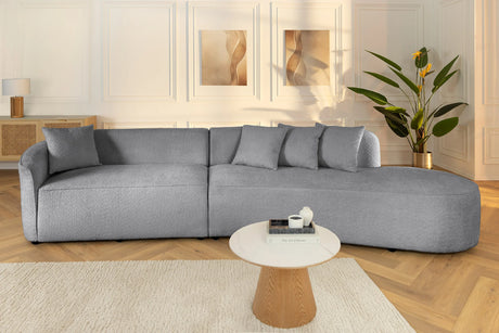 Beżowa sofa z tkaniny boucle o opływowym kształcie – nowoczesny mebel wypoczynkowy do eleganckiego salonu