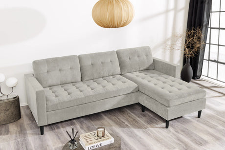 Nowoczesna sofa narożna w tkaninie cord, z otomaną lewą/prawą, tył tapicerowany, filcowe podkładki pod nogi