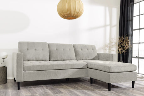 Nowoczesna sofa narożna w tkaninie cord, z otomaną lewą/prawą, tył tapicerowany, filcowe podkładki pod nogi