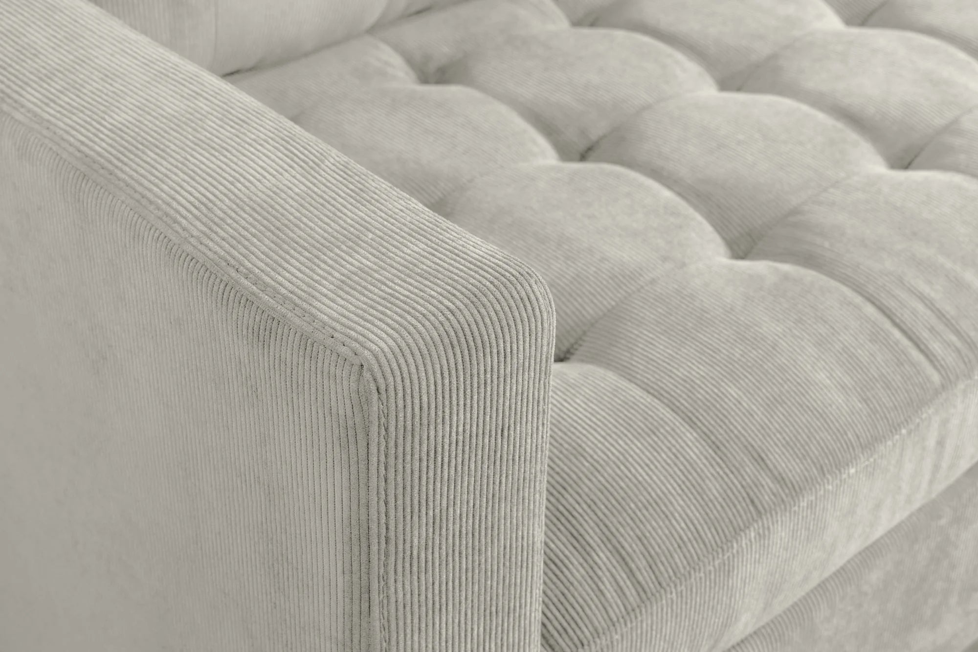 Nowoczesna sofa narożna w tkaninie cord, z otomaną lewą/prawą, tył tapicerowany, filcowe podkładki pod nogi