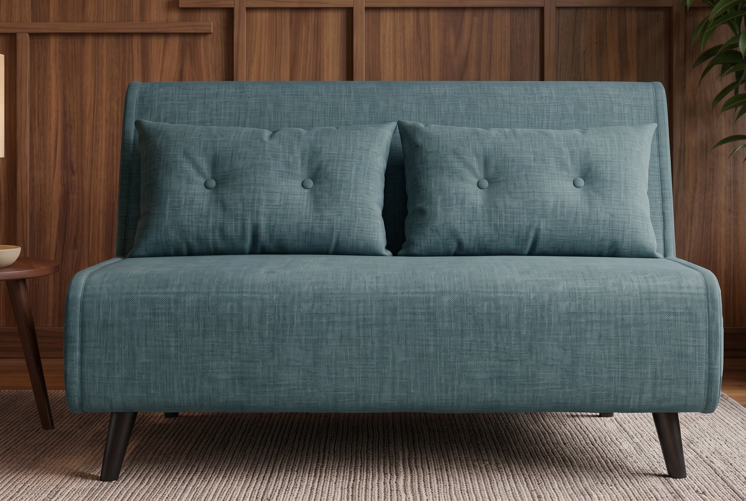 Niebieska sofa z funkcją spania 140 cm w tkaninie aksamit z drewnianymi nóżkami i poduszkami