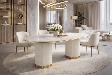 Nowoczesny stół w kolorze białym, owalnym blatem syntetycznym, na dwóch ryflowanych cylindrycznych nogach ze złotym wykończeniem.