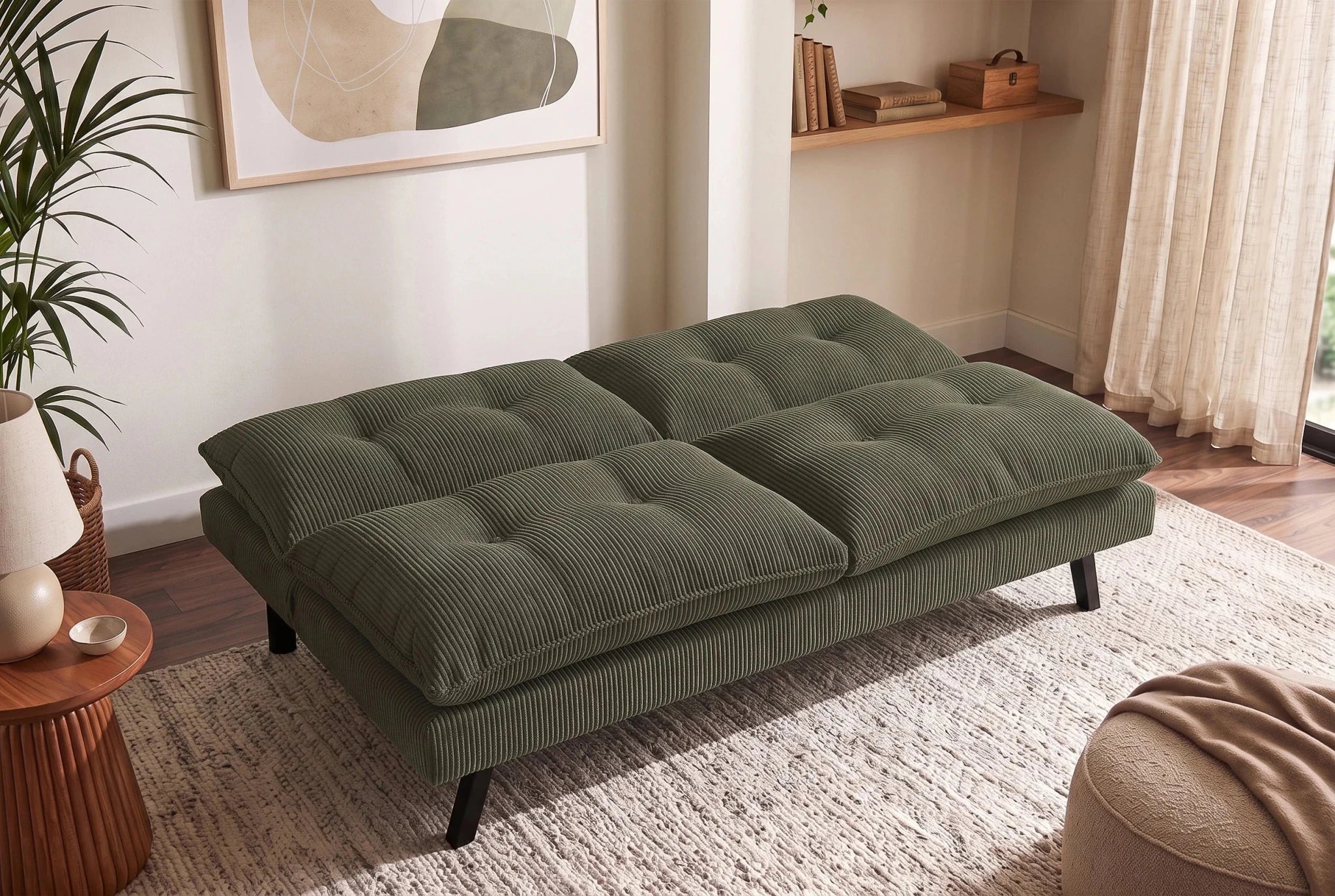 Zielona sofa rozkładana 190 cm z tapicerką sztruksową i czarnymi nogami drewnianymi