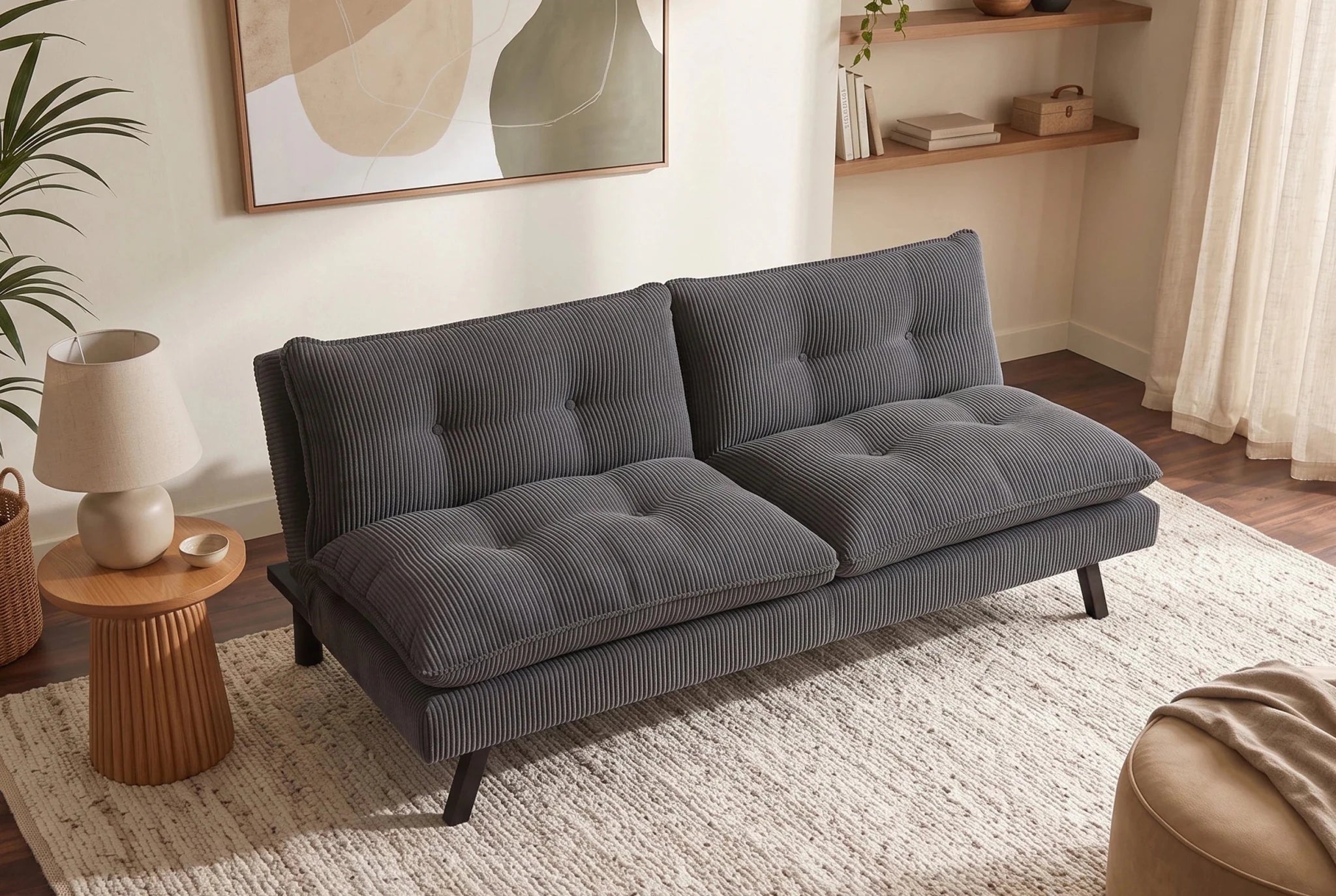 Szara sofa rozkładana 190 cm z tapicerką sztruksową i czarnymi nogami drewnianymi